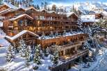 Experience luxury mountain living in this stunning wooden chalet nestled amidst snow-covered pines and majestic peaks.