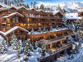 Experience luxury mountain living in this stunning wooden chalet nestled amidst snow-covered pines and majestic peaks.