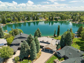 Experience luxury lakeside living in this stunning property, boasting direct access to a serene lake perfect for all your water activities.