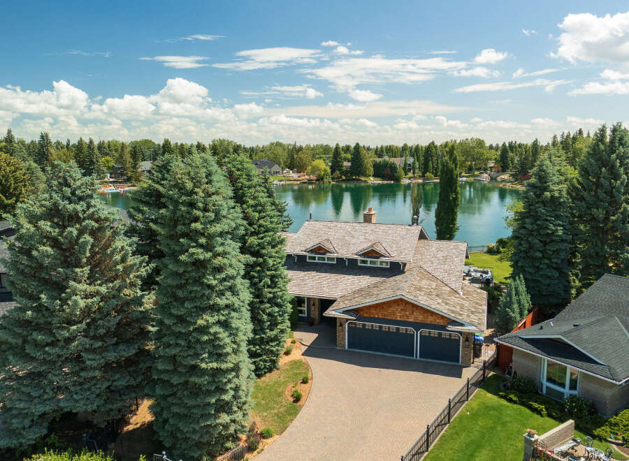 Experience luxury lakeside living in this stunning property featuring a spacious home with a multi-car garage and a beautifully landscaped yard.