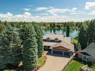 Experience luxury lakeside living in this stunning property featuring a spacious home with a multi-car garage and a beautifully landscaped yard.