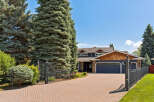 Discover this stunning property featuring a grand entrance with a paved driveway leading to a spacious home.