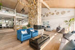 Experience luxurious living in this grand living room, featuring a striking stone fireplace as the centerpiece.