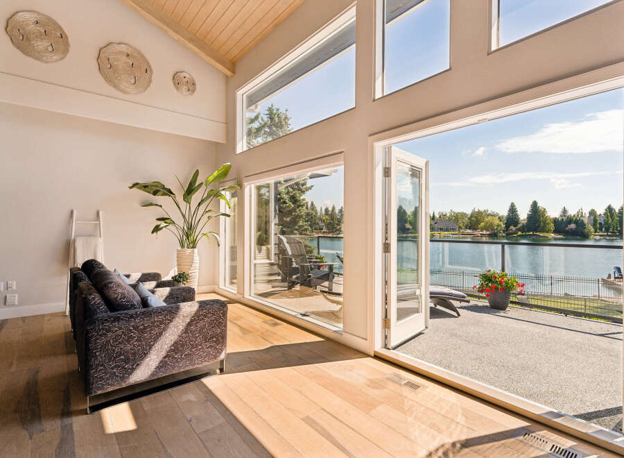 Experience luxurious lakeside living in this stunning home featuring expansive windows that flood the space with natural light and offer breathtaking water views.