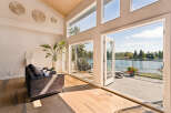 Experience luxurious lakeside living in this stunning home featuring expansive windows that flood the space with natural light and offer breathtaking water views.