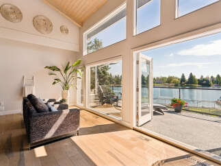 Experience luxurious lakeside living in this stunning home featuring expansive windows that flood the space with natural light and offer breathtaking water views.