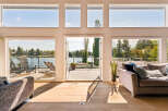 Experience luxurious lakeside living with this stunning property featuring expansive windows that flood the space with natural light and offer breathtaking views of the water.