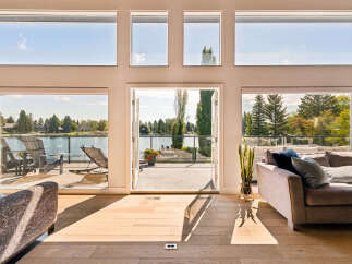 Experience luxurious lakeside living with this stunning property featuring expansive windows that flood the space with natural light and offer breathtaking views of the water.