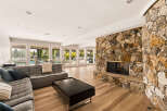 Experience luxurious living in this spacious great room, featuring a stunning floor-to-ceiling stone fireplace as the centerpiece.