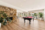 Experience ultimate relaxation and entertainment in this stunning recreational room, featuring a magnificent stone fireplace and a professional-grade pool table.