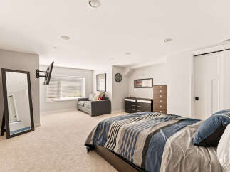 This spacious bedroom features a comfortable king-size bed with a stylish striped comforter, perfect for a restful night's sleep.