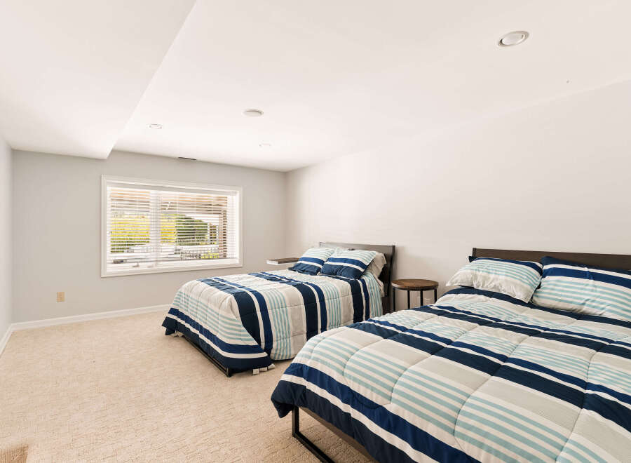 This spacious bedroom features two comfortable beds, perfect for accommodating guests or family.