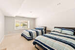 This spacious bedroom features two comfortable beds, perfect for accommodating guests or family.