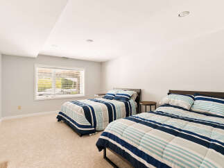 This spacious bedroom features two comfortable beds, perfect for accommodating guests or family.