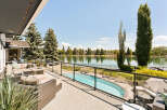 Experience luxury lakeside living with this stunning property featuring a private pool and expansive patio overlooking a serene lake.
