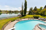 Experience luxury waterfront living with this stunning property featuring a private pool and spa overlooking a serene lake.