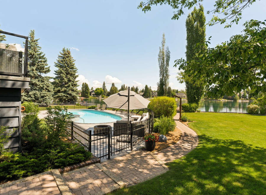 Enjoy resort-style living in this stunning backyard oasis, complete with a sparkling swimming pool and a cozy fire pit perfect for evening gatherings.