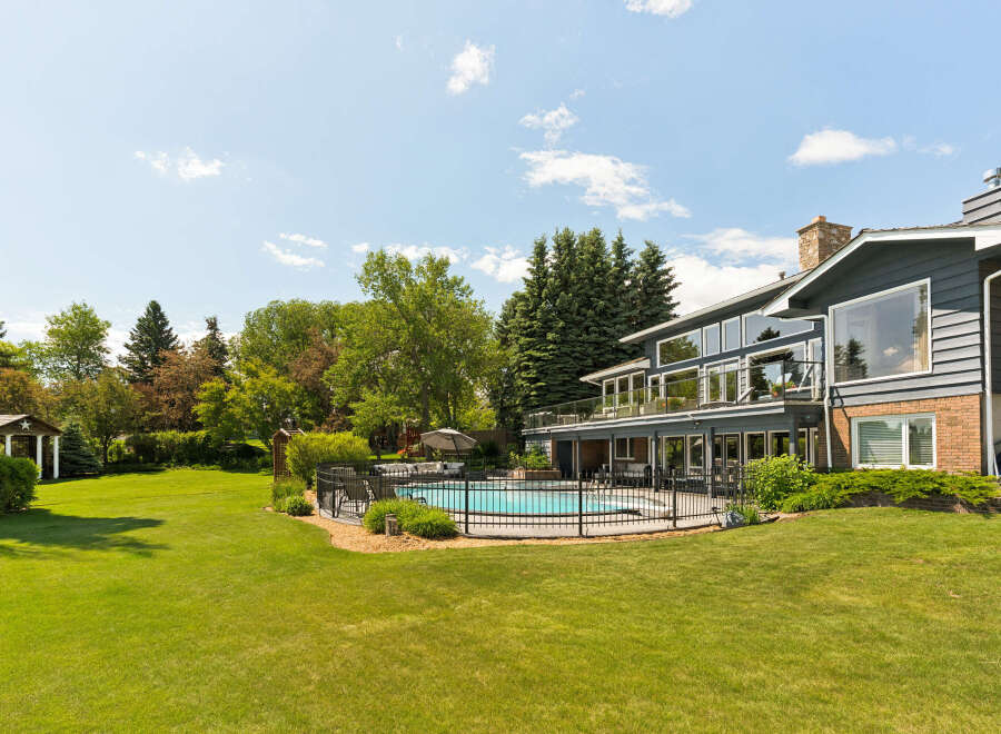This stunning property boasts a beautifully landscaped backyard featuring a sparkling swimming pool, perfect for summer relaxation and entertainment.