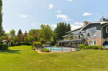 This stunning property boasts a beautifully landscaped backyard featuring a sparkling swimming pool, perfect for summer relaxation and entertainment.