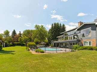This stunning property boasts a beautifully landscaped backyard featuring a sparkling swimming pool, perfect for summer relaxation and entertainment.