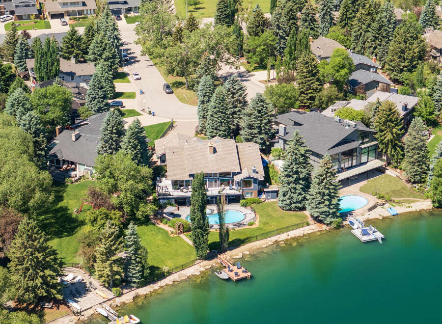 Experience luxury waterfront living in this stunning estate, boasting a private pool and direct lake access.