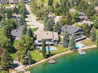Experience luxury waterfront living in this stunning estate, boasting a private pool and direct lake access.