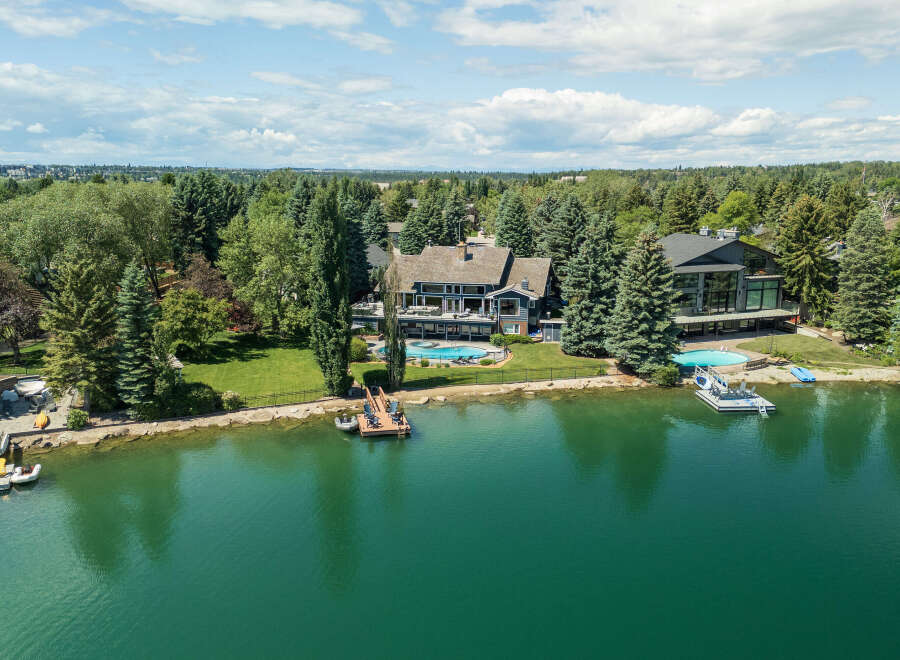 Experience luxury waterfront living in this stunning estate featuring a private dock and two sparkling swimming pools.