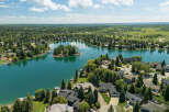 Experience luxury lakeside living in this stunning aerial view of a waterfront community.