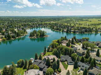 Experience luxury lakeside living in this stunning aerial view of a waterfront community.