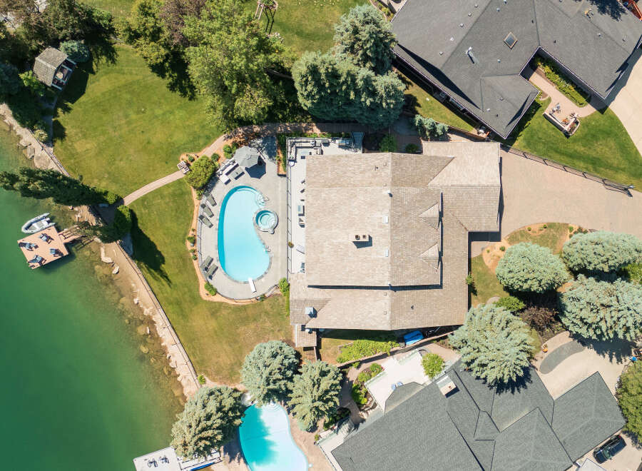 Experience luxury living with this stunning aerial view of a lakeside estate.