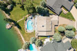 Experience luxury living with this stunning aerial view of a lakeside estate.