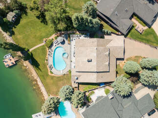 Experience luxury living with this stunning aerial view of a lakeside estate.