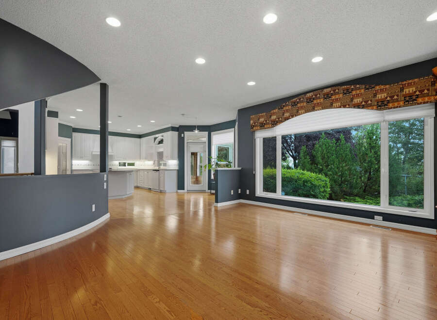 Experience spacious living in this open-concept home featuring gleaming hardwood floors and a large bay window with picturesque backyard views.