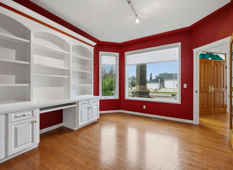 This home office features a stunning built-in white bookshelf and desk unit, perfect for organization and productivity.