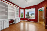 This home office features a stunning built-in white bookshelf and desk unit, perfect for organization and productivity.