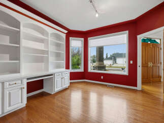 This home office features a stunning built-in white bookshelf and desk unit, perfect for organization and productivity.