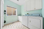 Discover a functional laundry room featuring a washing machine and dryer, perfect for managing household chores.