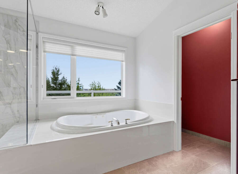 Indulge in relaxation in this luxurious bathroom, featuring a spacious jacuzzi tub perfect for unwinding.