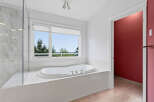 Indulge in relaxation in this luxurious bathroom, featuring a spacious jacuzzi tub perfect for unwinding.