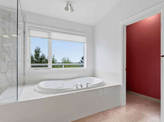 Indulge in relaxation in this luxurious bathroom, featuring a spacious jacuzzi tub perfect for unwinding.