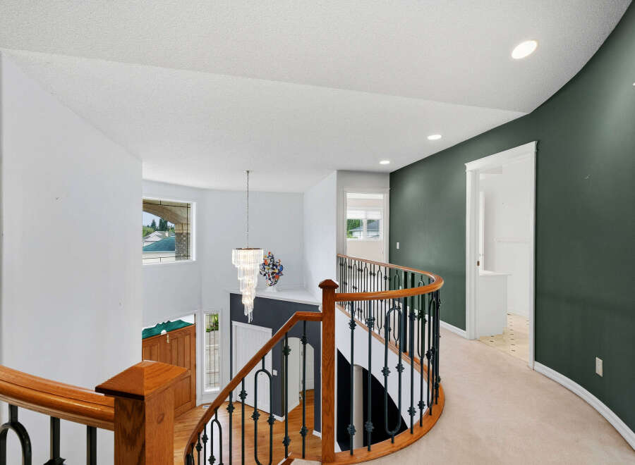 This stunning home features a grand staircase with a beautiful chandelier, perfect for making an entrance.