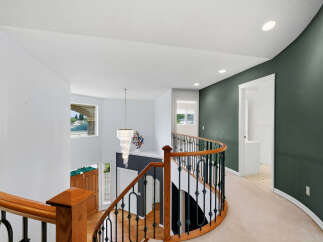 This stunning home features a grand staircase with a beautiful chandelier, perfect for making an entrance.