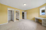 Discover this charming bedroom featuring a spacious layout and a built-in desk, perfect for a home office or study area.