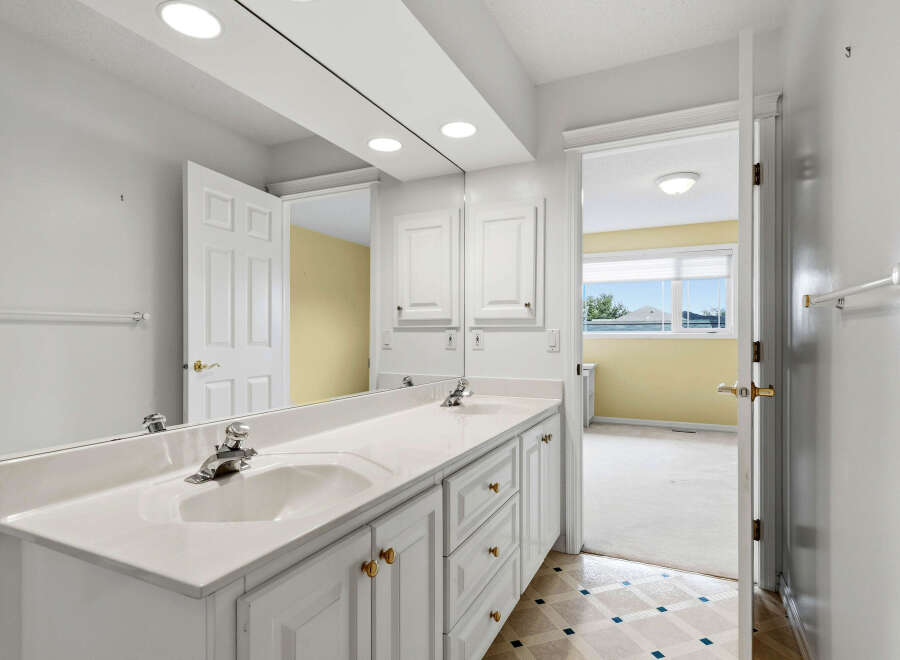 This spacious bathroom features a double vanity with ample counter space and storage, perfect for busy mornings.