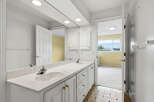 This spacious bathroom features a double vanity with ample counter space and storage, perfect for busy mornings.