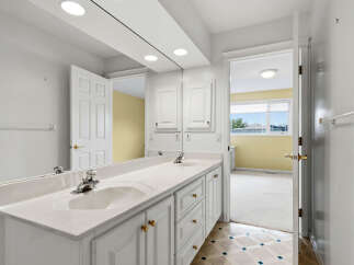 This spacious bathroom features a double vanity with ample counter space and storage, perfect for busy mornings.