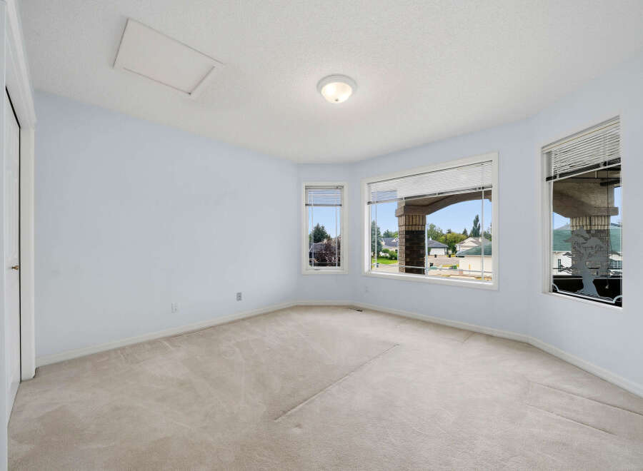 Discover this spacious room with a large bay window offering scenic views of the neighborhood.