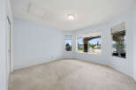 Discover this spacious room with a large bay window offering scenic views of the neighborhood.