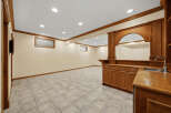 This finished basement features a spacious entertainment area with a built-in bar, perfect for hosting guests.