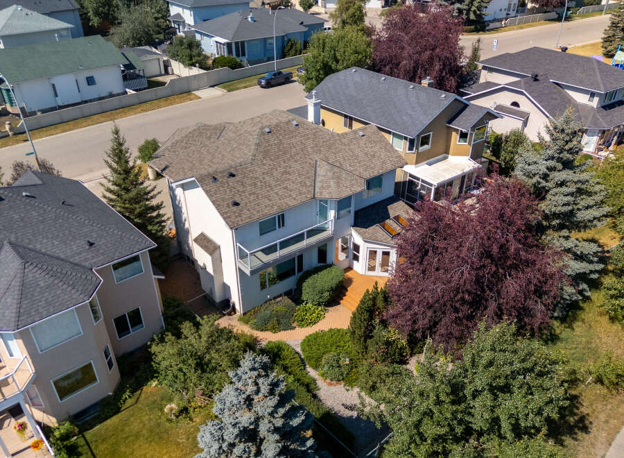 Discover this stunning multi-level home featuring a spacious deck with glass railings, perfect for outdoor entertaining.